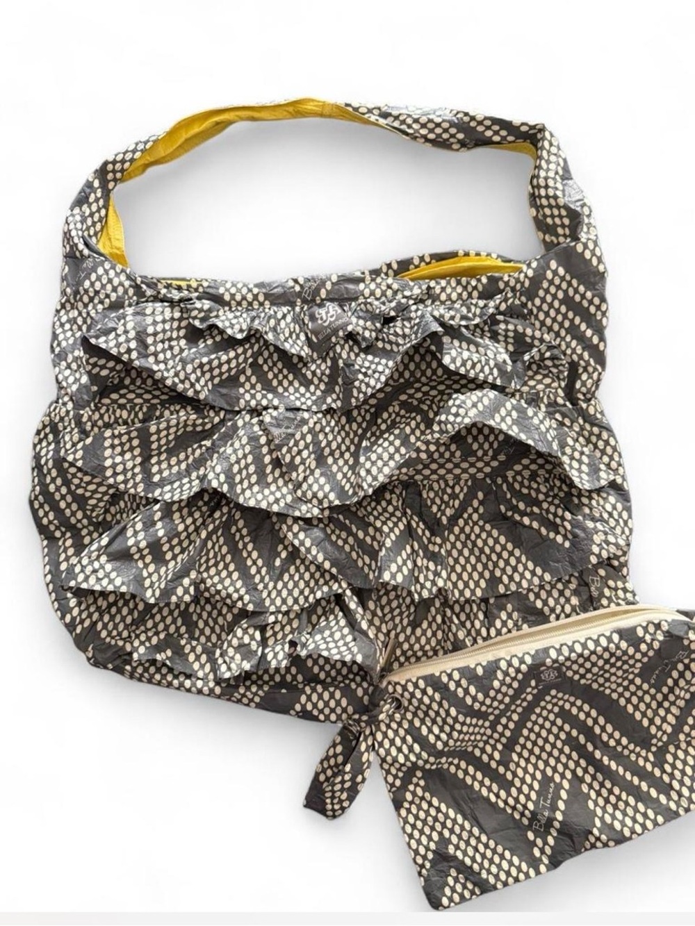 Bella Tunno gray & white polka dot ruffled diaper bag with bonus zipper pouch.
